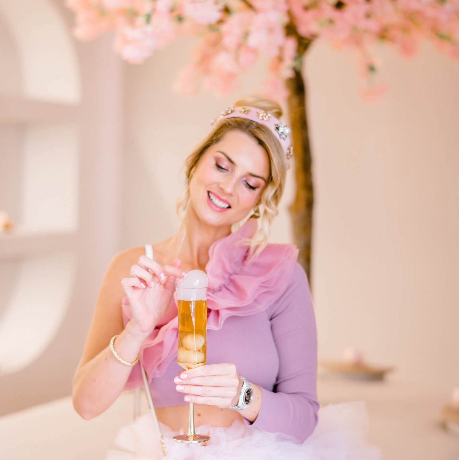 Woman holding a lychee mocktail