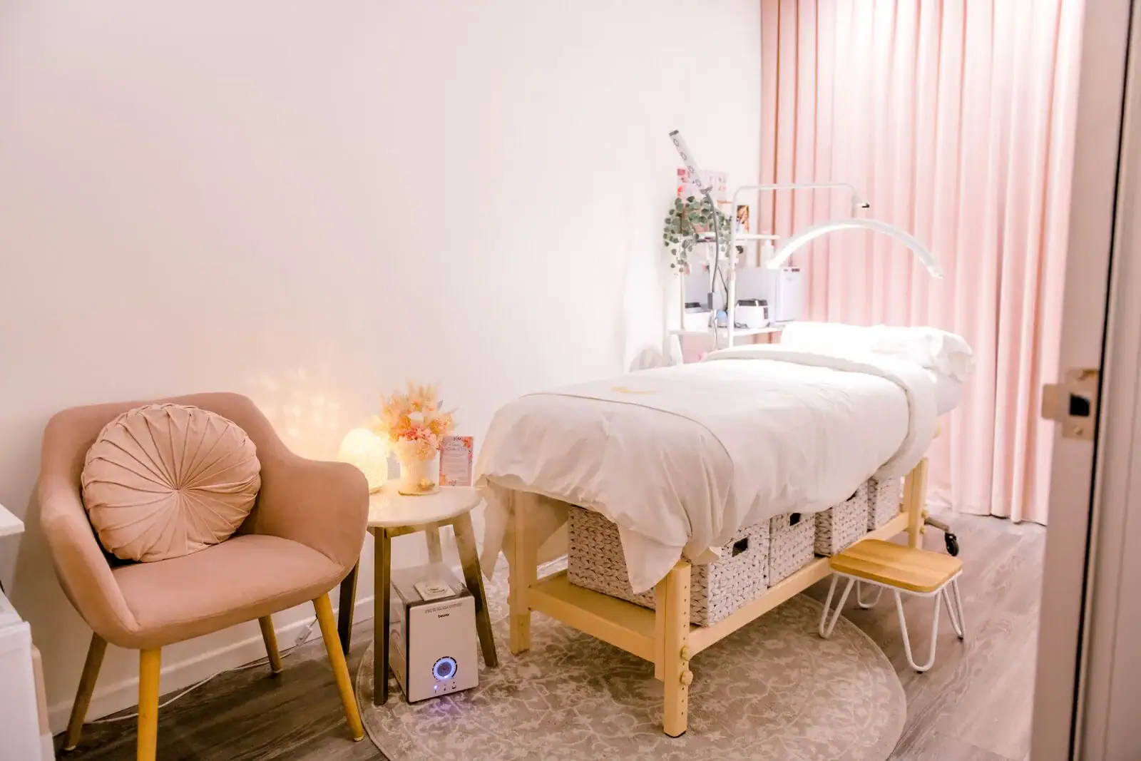 Wide view of a private treatment suite at The Lash Spa, with its bed and seating